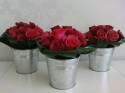 Rose table arrangement in galvanised steel pots