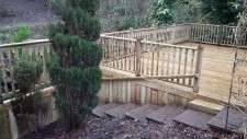 Decking along river frontage with gate