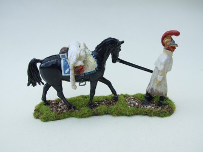 CARBINER TROOPER LEADING HORSE WITH WOUNDED COMRADE SLUMPED OVER SADDLE